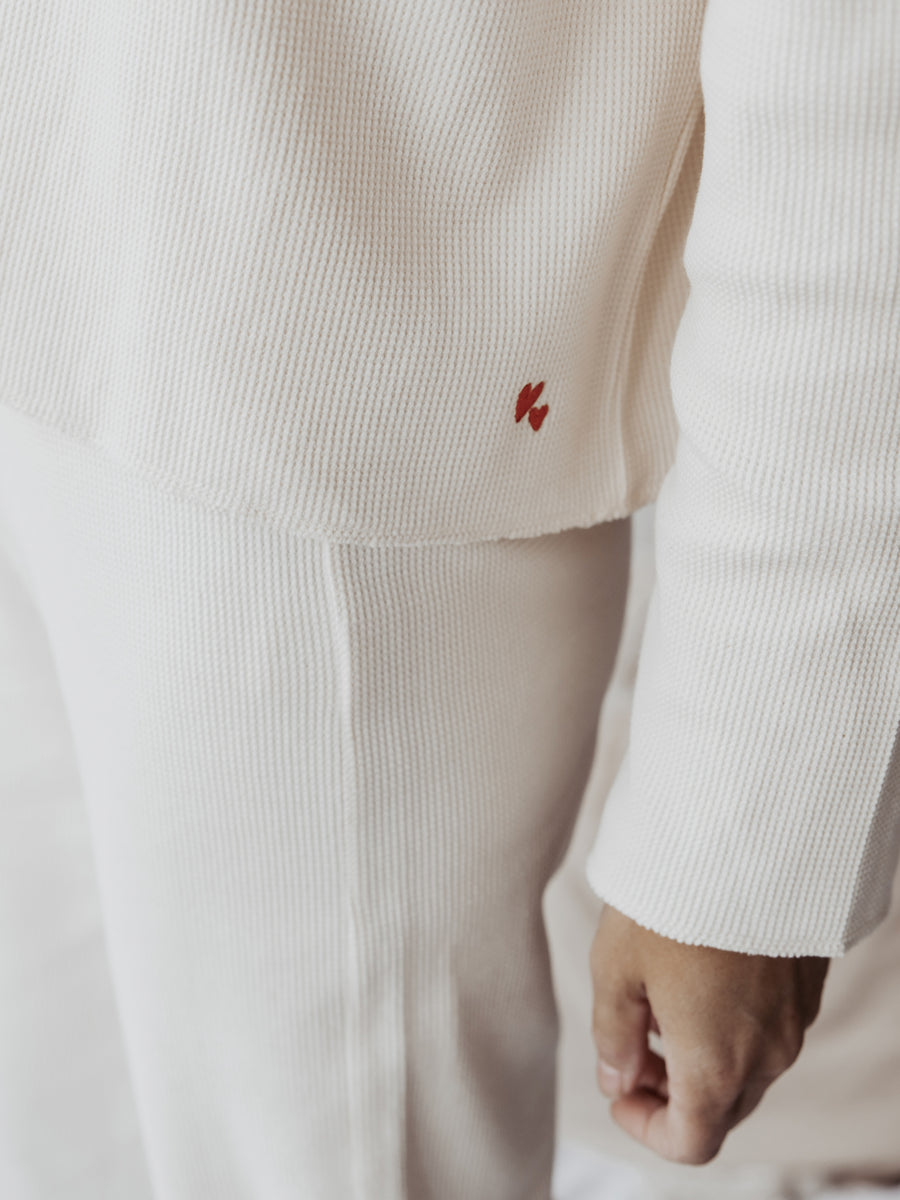 Details of Matching Sweater Atelier Rive in Tofu with Heart Embroidery Logo